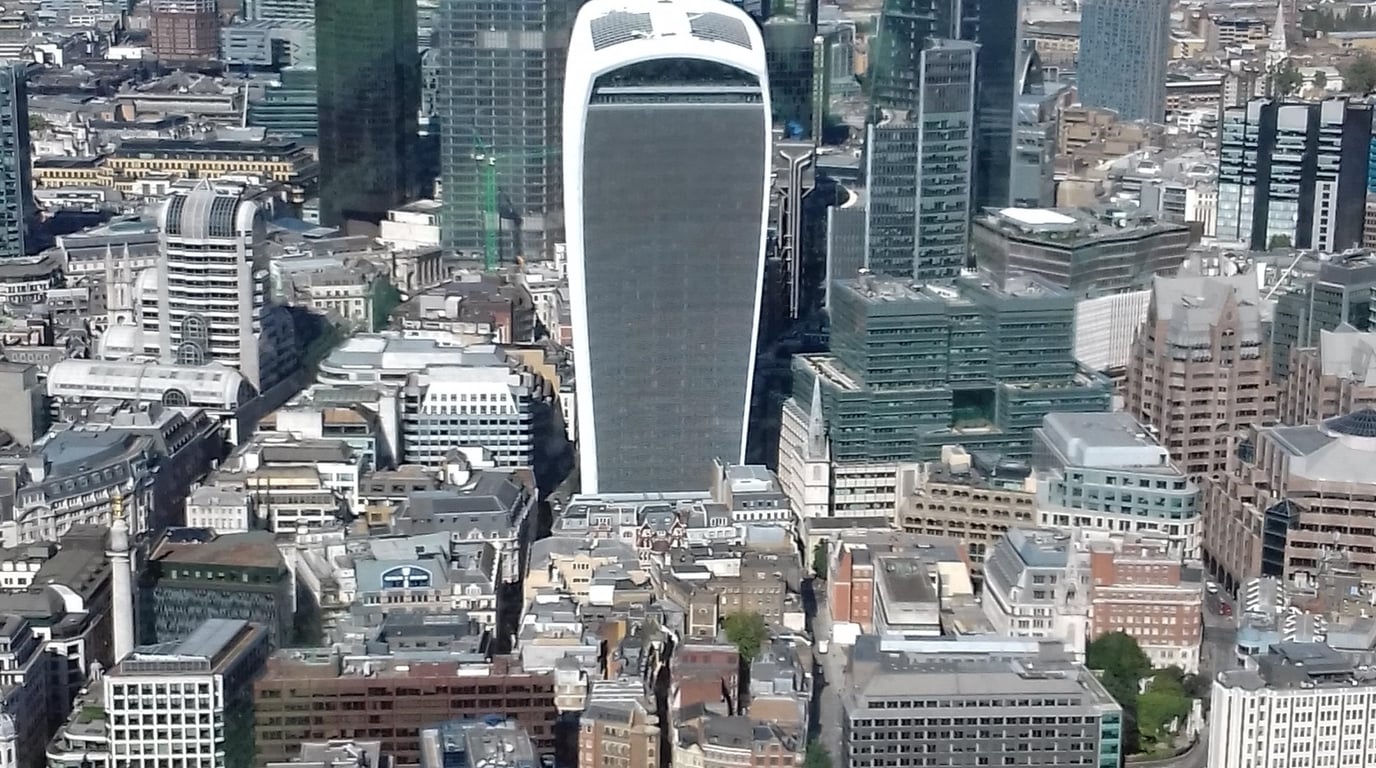 The City of London skyline seen across the Thames, with office towers catching the afternoon light