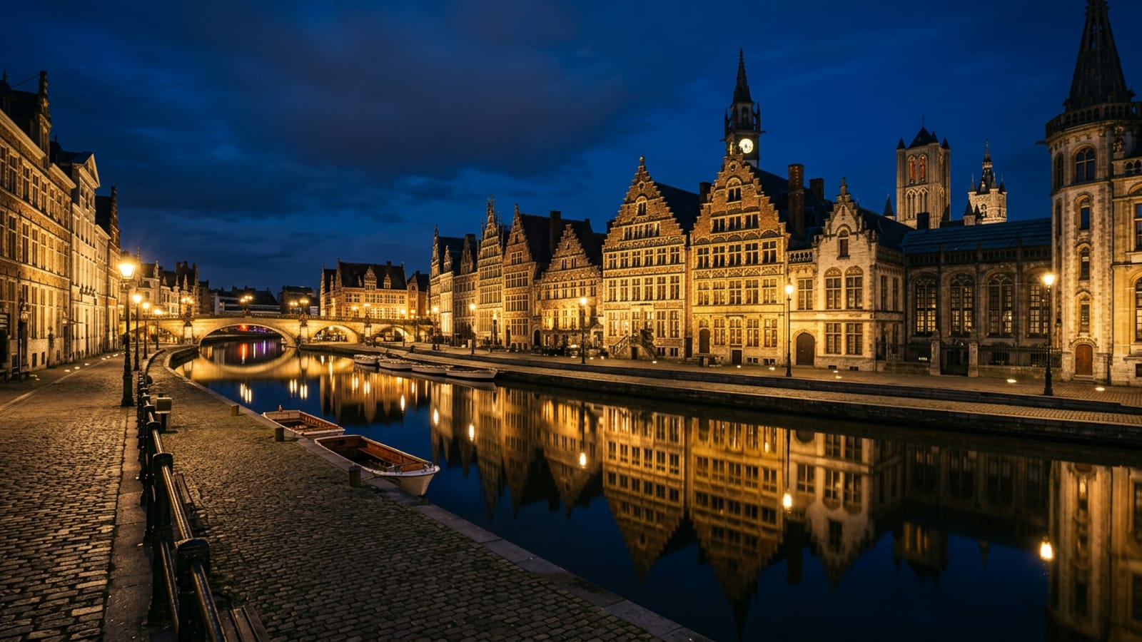 The Graslei canal waterfront in Ghent at blue hour with lit medieval guild houses reflected in still water