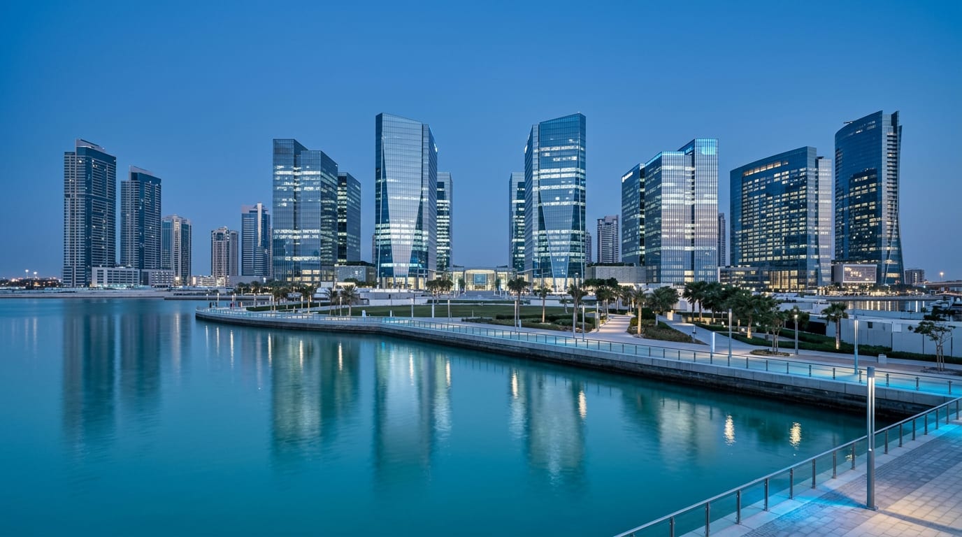 Modern glass towers in Abu Dhabi under a bright blue sky