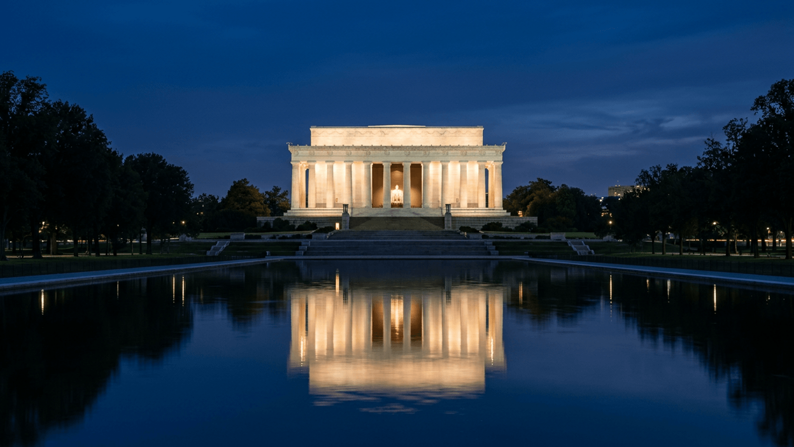 Classical government building with columns in Washington DC at blue hour, reflected in a pool